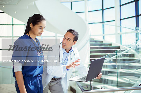 Doctor and nurse using laptop in hospital