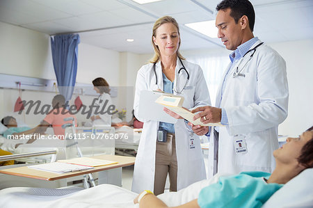 Doctors talking to patient in hospital room