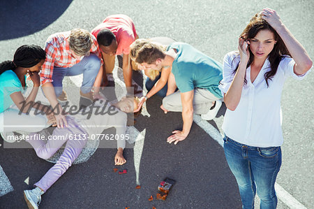 Woman calling emergency services at car accident