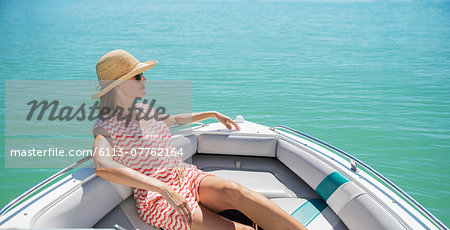 Women relaxing in boat on water