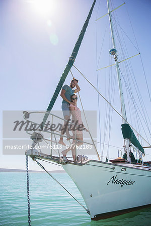 Couple standing on front of boat