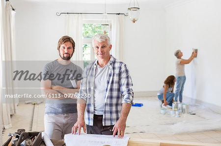 Father and son looking through construction plans