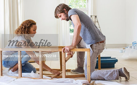 Couple building furniture together