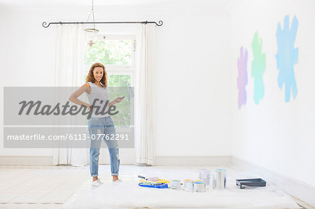 Woman painting walls in living space