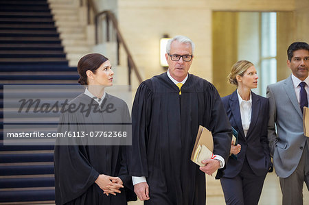 Judges and lawyers walking through courthouse