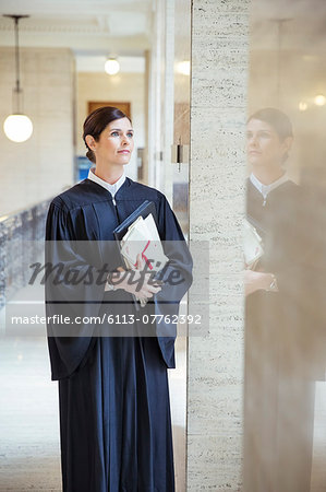 Judge looking out window in courthouse