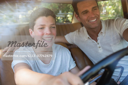 Father teaching son to drive