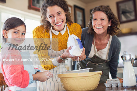 Three generations of women baking together