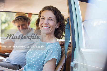 Older couple sitting in front seat of car