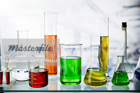 Beakers of various solutions on shelf in lab