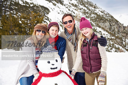 Family building a snowman together