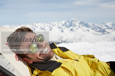 Man laying on a chair in the snow