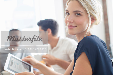 Businesswoman using digital tablet at meeting