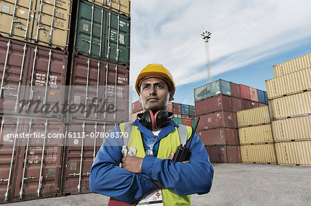 Worker standing near cargo containers