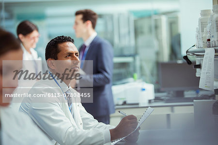 Scientist taking notes on experiment in laboratory