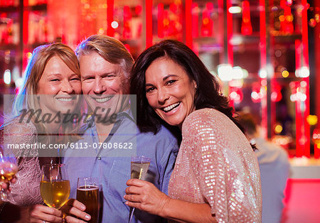 Portrait of smiling mature man and women in nightclub