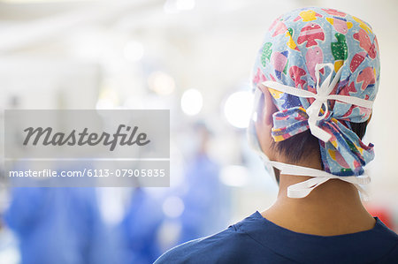 Rear view of young nurse standing in operating theater