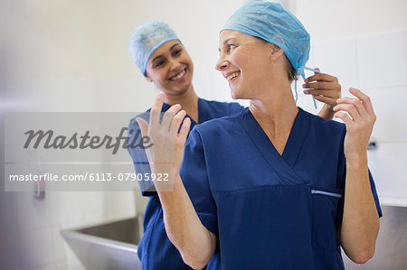 Two smiling surgeons getting ready for surgery