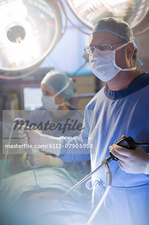 Surgeon performing laparoscopic surgery in operating theater