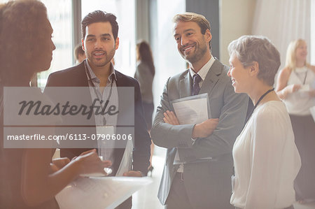 Group of business people smiling and discussing in office