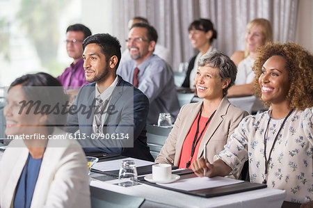 Group of people sitting and listening to speech during seminar