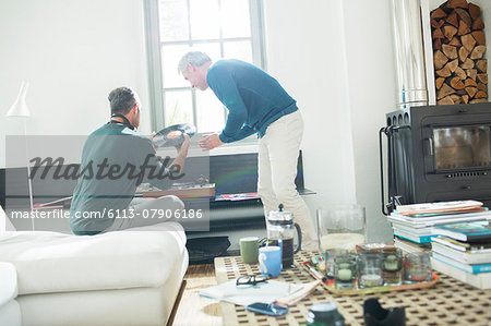 Gay couple listening to vinyl records Gay couple listening to vinyl records