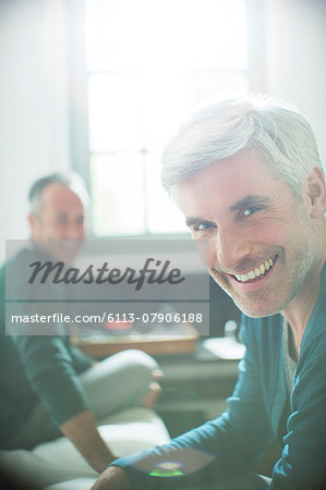 Gay couple relaxing together with record player Gay couple relaxing together with record player
