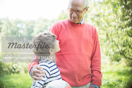 Grandfather and grandson hugging outdoors