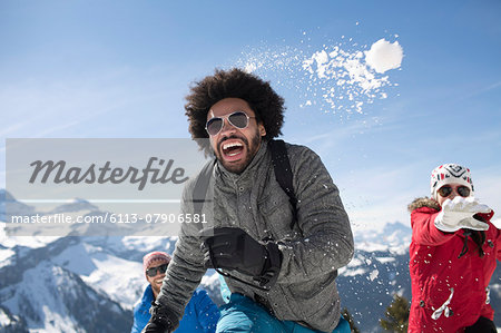 Friends enjoying snowball fight