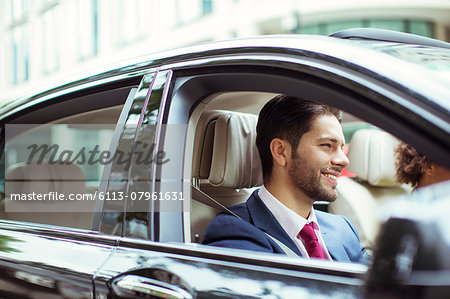 Businessman smiling in car