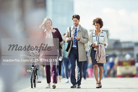 Business people walking and talking in city