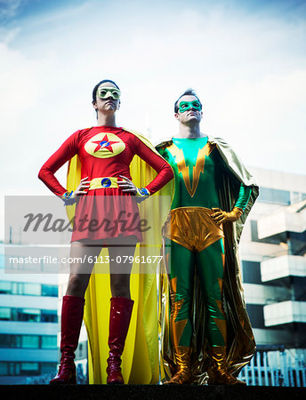 Superheroes standing on city rooftop