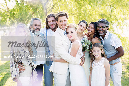 Portrait of young couple and guests during wedding ceremony