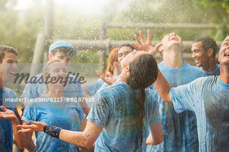 Enthusiastic team enjoying rain at boot camp