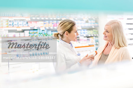 Pharmacist and customer talking in pharmacy