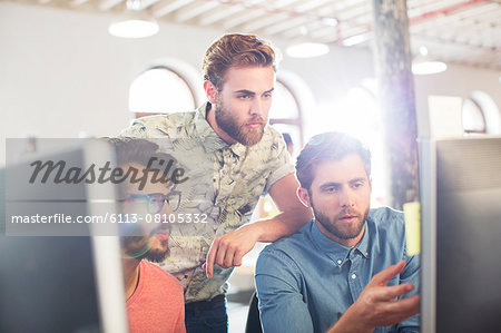 Focused casual businessmen working at computers