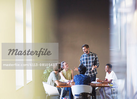 Casual businessman leading meeting at office table Casual businessman leading meeting at office table