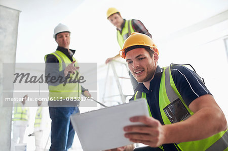 Construction workers with digital tablet at construction site