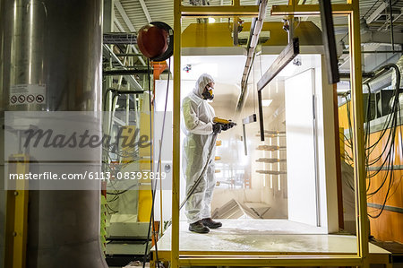 Worker operating machinery in factory