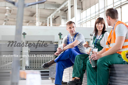 Workers enjoying coffee break in factory