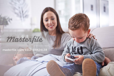 Curious toddler using cell phone