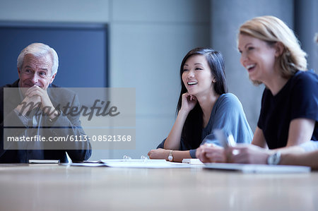 Businesswomen laughing in meeting