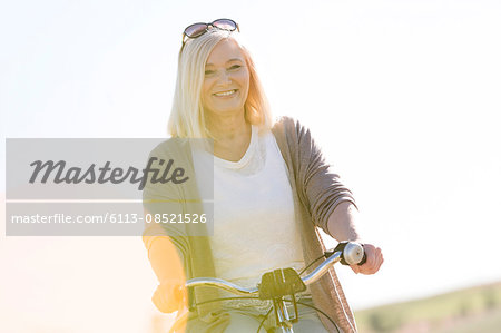 Portrait smiling senior woman bike riding