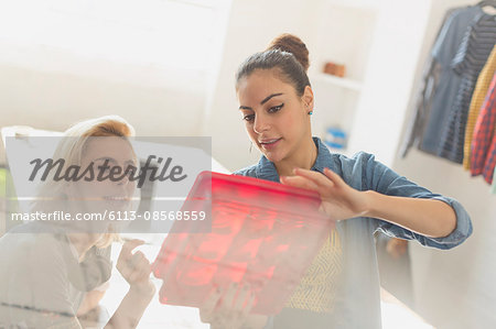 Innovative young businesswomen examining prototype