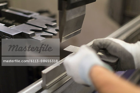 Close up worker using machinery in steel factory Close up worker using machinery in steel factory