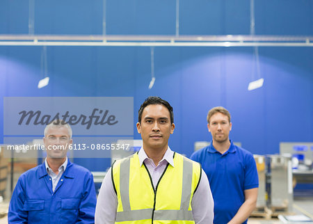 Portrait confident manager and workers in steel factory