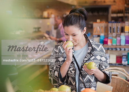 Woman smelling pears in market Woman smelling pears in market