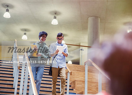 College students with notebook descending stairway