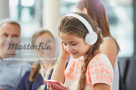 Girl listening to music with headphones and mp3 player