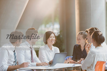 Business people talking at laptop in conference room meeting Business people talking at laptop in conference room meeting